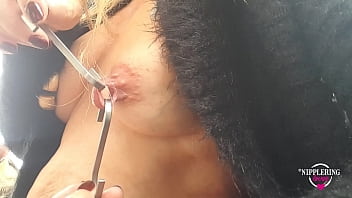 Sexy mom shows off her extreme nipple piercings outdoors